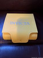 Closed yellow Invicta branded travel watch box