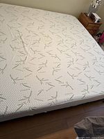 Photo of a king size foam mattress covered with white fabric featuring bamboo print.