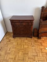 Front view of cabinet with closed drawer and doors