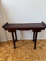 Front view of the rosewood Chinese altar table showing the carved apron and straight legs.
