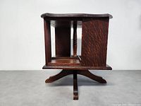 Side view showing open compartments and repaired leg on the pedestal base.