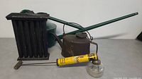 Photo showing all four items: green watering can, rusty metal jug, yellow bug killer pump, black coin bank mold