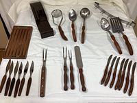 Full overview of racks, utensils, knives and forks laid out on sheet
