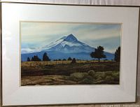 Framed watercolor painting showing Mt. Hood landscape with field and trees in foreground.