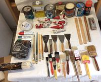 Wide view of entire lot showing brushes, paint cans, tools, stir sticks, hand sanders, markers, and steel wool