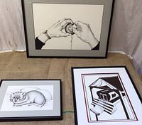 Group photo showing all three framed stipple art pieces on display: hands peeling fruit, abstract book structure, and reclining cat.