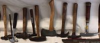 Row of various hammers and hatchet
