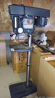 Full side view of floor drill press on base