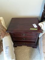 Front quarter view of three drawer mahogany nightstand