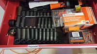Drawer with assorted black sockets, Remington power fasteners, and small hand tool