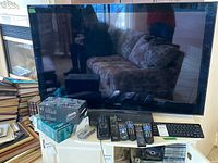 Sony 46-inch TV on stand with remotes and wireless keyboard in front