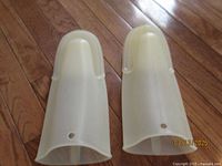 Cream-colored plastic baking mitts with grip texture and ventilation holes