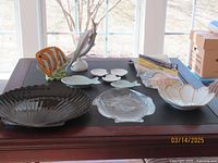 Overview of all beach-themed items including dishes and figurines on a table
