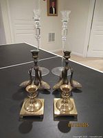 Photo showing all candle holders: crystal, brass swans, and small brass holders together.