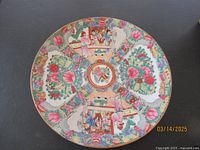 Top view of Chinese Famille Rose porcelain plate decorated with colorful floral and figure scenes