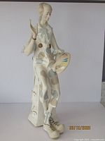 Full view of the clown figurine showing costume and overall pose