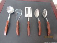 Full set of 5 Cutco kitchen tools on black background showing all utensils with stainless steel heads and wooden handles