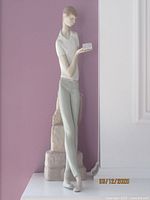 Full front view of vintage Lladro figurine showing boy in white polo and gray pants holding book