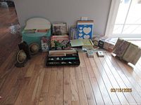 Full overview of all items in the lot including bookends, pencils, playing cards, stationery, trivia and greeting cards, and vintage book.