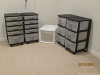 Wide angle photo showing all 5 plastic organizers in a corner of a room.