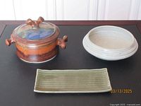 Overview of three pottery pieces: lidded pot, round bowl, rectangular tray