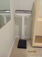 Full view of the entire Health o Meter balance beam scale showing the black base, white stand, and balance beam at the top.