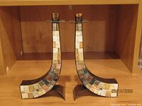 Front view of two candlesticks showing the stone inlay.