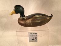 Side view of the hand carved Mallard Drake decoy showing the dark green head with detailed yellow bill and brown painted body with light paint wear.