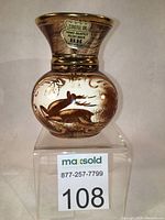 Front view showing hand painted leaping stag with label 'Castel Or Hand Painted Paint Main BH Made in Belgium'