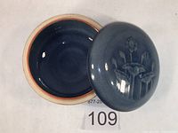 Top angle view of open jar showing glazed interior and lid placed beside it.