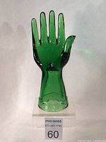 Front view of green Depression glass hand display showing height and finger positioning.
