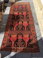 Full view of rug laid flat showing overall geometric pattern and border