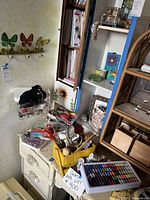 Yellow wooden caddy filled with scissors, hand tools and wooden ruler