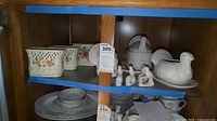 Three ceramic Victorian planters, two ceramic turkey serving bowls with matching saucers, and seven ceramic napkin rings with bird design on shelf
