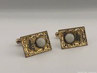 Two rectangular 14K yellow gold cufflinks displayed on neutral background, front view