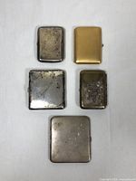 Five cases arranged front side up: two top, two middle, one bottom