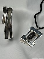 Side view of silver cuff bracelet highlighting texture and finish