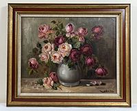 Frontal image showing the entire framed painting of roses in a white vase on table.