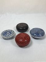 Overhead shot of all four boxes arranged in a square, showing top designs and colors