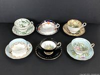Full set of 6 teacups with saucers showing different designs