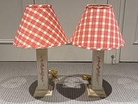 Pair of rectangular pine table lamps with shabby chic painted floral designs and red/white checked fabric shades, shown side by side on carpet floor.
