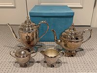 Full set arranged on carpet with vintage blue Birks box behind