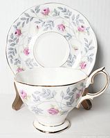 Front angle view of Royal Albert fine bone china teacup and saucer in Conway pattern, showing floral design and gold trim.