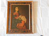Front view of the antique hand painted Italian wooden frame with the Medici Society early print of an Italian Masterpiece showing a young woman kneeling in a red dress, holding a cloth.