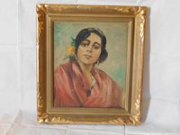 Full front view of the framed painting showing the woman and gold-gilt frame.