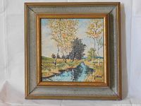 Front view of the framed painting showing an autumn Ontario birch landscape by a stream, with signature 'John' visible, and the textured gray and gold wooden frame.