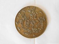 Obverse with abstract dancing figures.