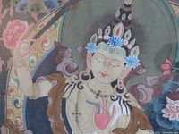Close-up of White Tara’s face, floral tiara and upper torso