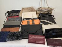 Photo of 14 assorted vintage purses showing variety in styles and colors including leather, fabric, and beaded bags.