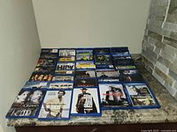 Photo showing rows of Blu-Ray movie cases arranged on a flat surface, titles visible include The Dark Knight, The Good The Bad and The Ugly, Batman Returns, and others.